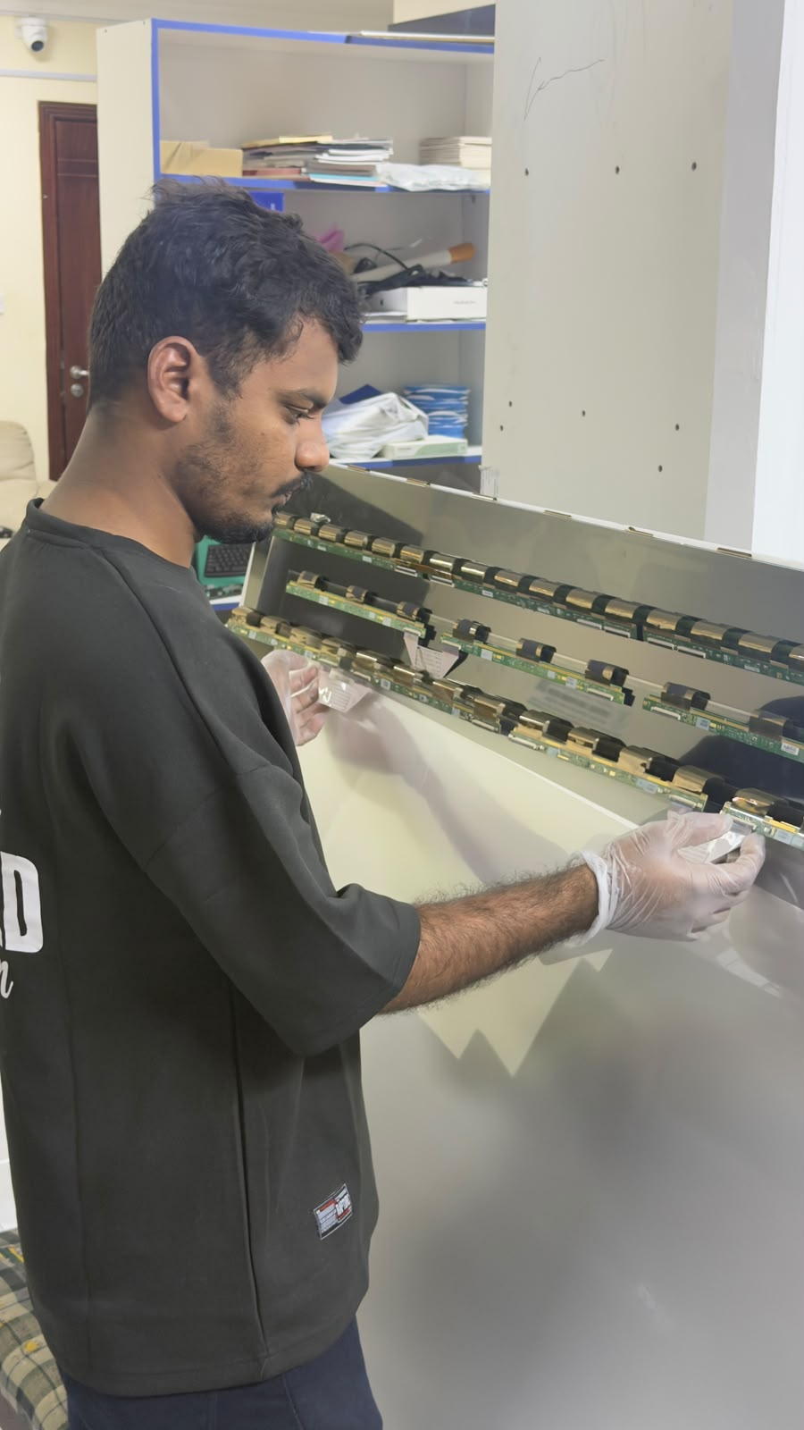 Technician repairing television electronic components
