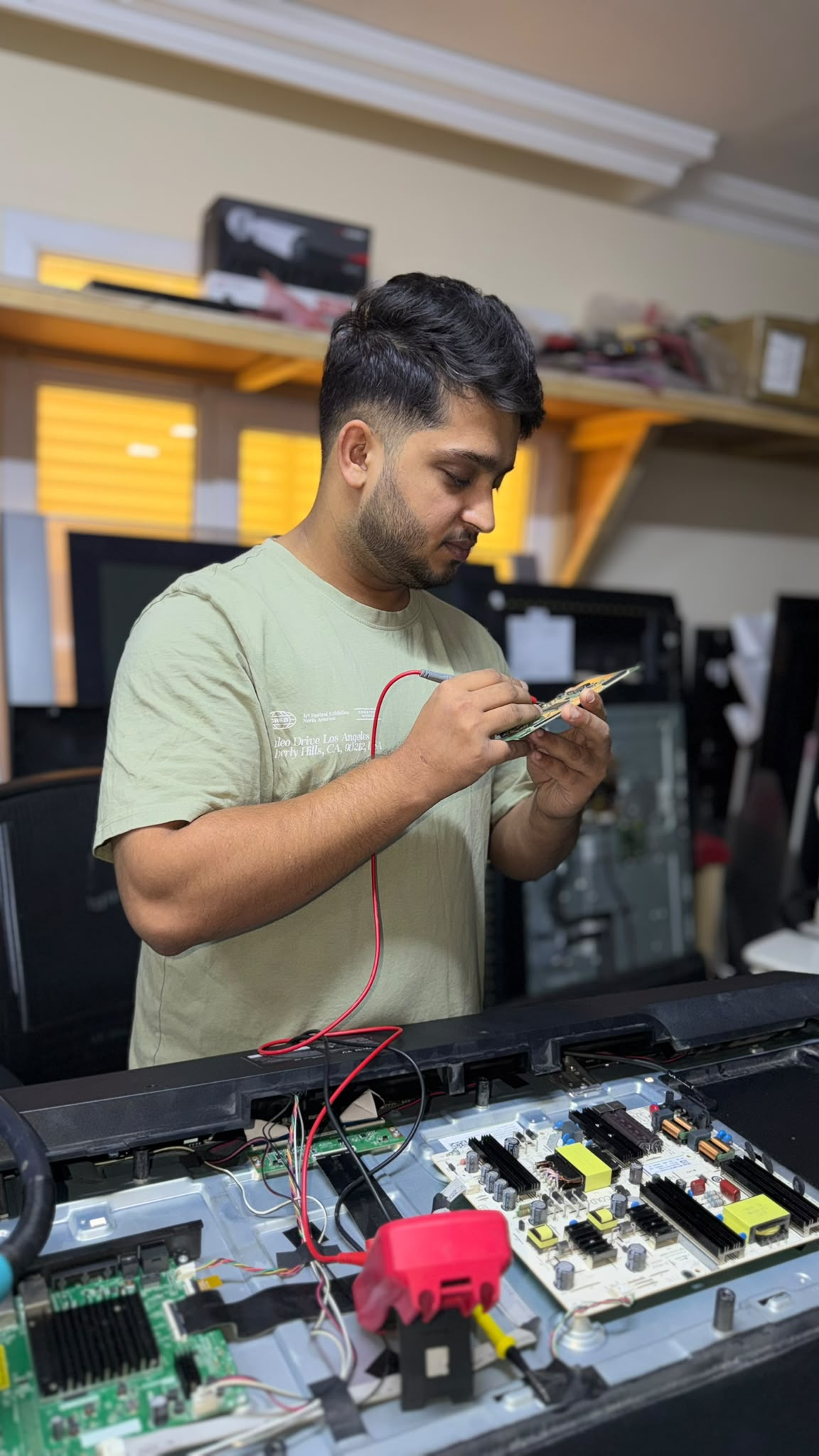 Technician diagnosing a television